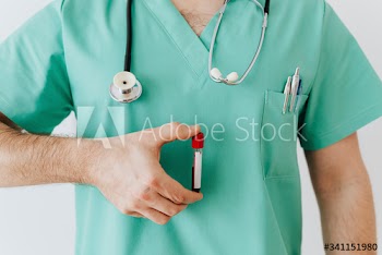 Surgeon holding a blood test tube