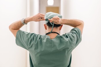 Surgeon Tying Head Scarf