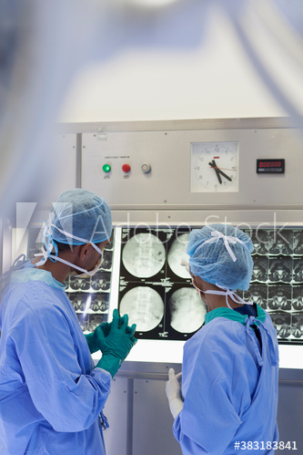 Surgeons discussing x-rays in operating room