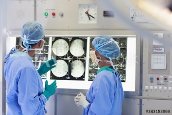 Surgeons examining x-rays in operating room