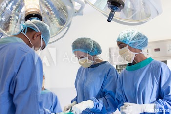 Surgeons operating in hospital operating room