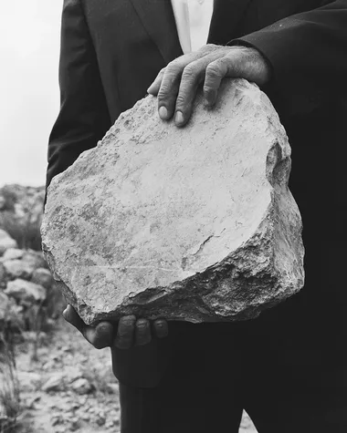 Surreal Burden: A Man Carrying a Stone Surreal Burden: A Man Carrying a Stone