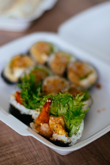 Sushi on Plastic Case on Wood Plank