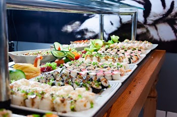 Sushi on White Plates on Brown Wooden Table