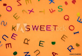 Sweet spelled word with alphabets background