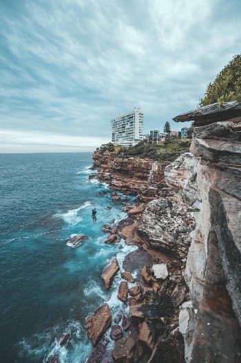 Sydney's coastal cliffs are a great spot to Highline. Athlete is harnessed and using backup equipment for safety. 