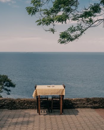 Tablecloth and the Table for 2 Nearby the Sea · Free Stock Photo