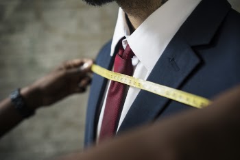 Tailor Measuring Man's Chest