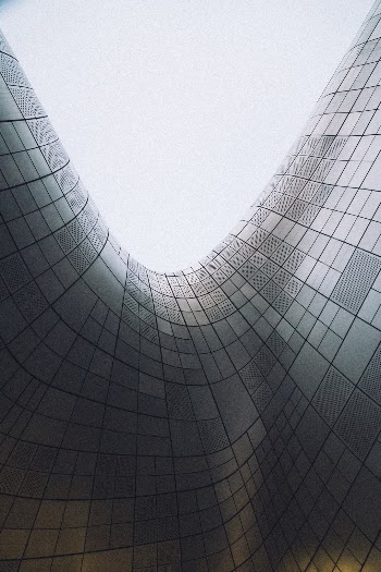Taken in Dongdaemun Design Plaza I had to almost laydown on the ground to get this shot upwards towards the sky on the overhang of the building's structure.