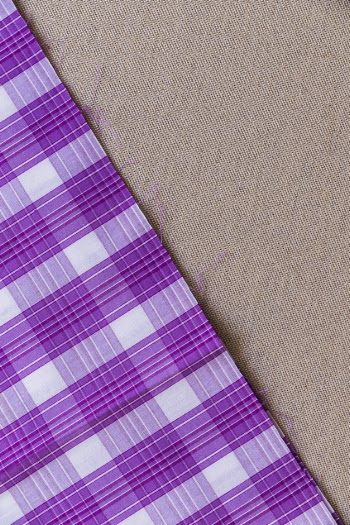 Tartan plaid fabric on plain textile