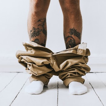 Tattooed man caught with pants down