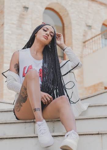 Tattooed Woman Sitting On Stairs