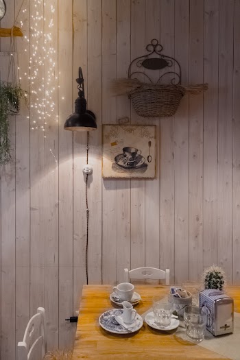 Teacups and Saucers Beside Cactus Plant on Brown Table