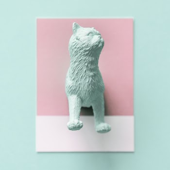 Teal Cat Figurine on White Surface