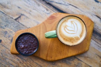 Teal Ceramic Mug on Brown Wooden Panel