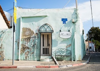 teal concrete building beside road at daytime