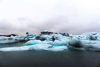 teal ice berg during daytime