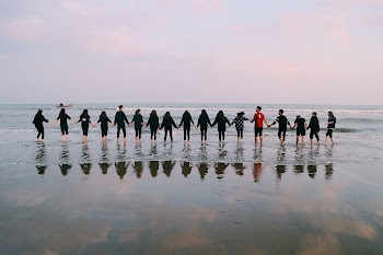Team Holding Their Hands On Seashore · Free Stock Photo