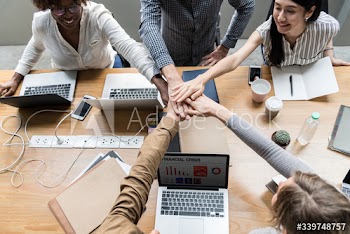 Team of business people stacking hands
