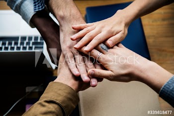 Team of business people stacking hands