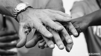 Team of business people stacking hands