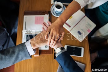Team of business people stacking hands