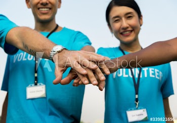 Team of volunteers stacking hands