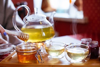 Teapot And Teacups With Tea And Honey On Tray