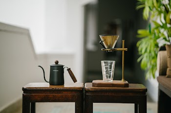 Teapot Beside Drinking Glass on Tables
