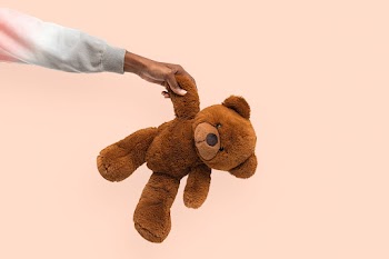 Teddy bear held by a hand for charity… | Free stock photo | High Resolution image