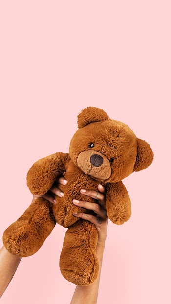 Teddy bear toy held by a hand for kids | Free stock photo | High Resolution image