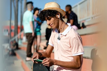 Teen boy listen to music, at a skatepark in… | Free stock photo | High Resolution image