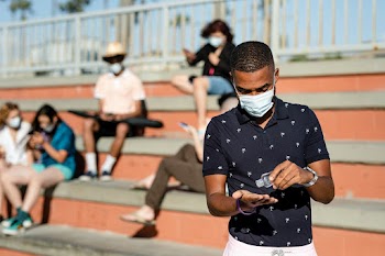 Teen boy using hand sanitizer outdoors in the… | Free stock photo | High Resolution image
