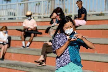 Teen girl using hand sanitizer outdoors in… | Free stock photo | High Resolution image