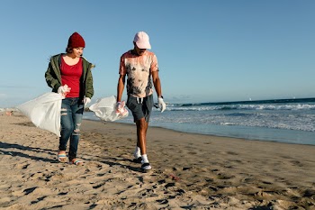 Teenagers cleaning beach, picking up trash… | Free stock photo | High Resolution image