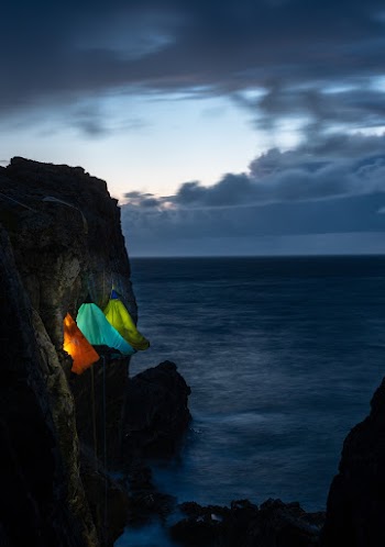 Tents With Lights Hanging On Cliff
