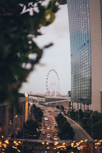 Terrace Overlooking Vehicles Passing on Road and Ferris Wheel