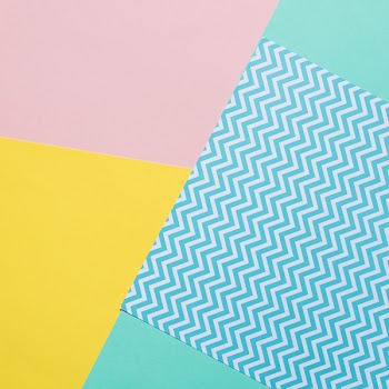 Texture background of fashion pastel colors: pink, yellow, turquoise and geometric pattern papers in minimal concept. Flat lay, Top view. 90s style