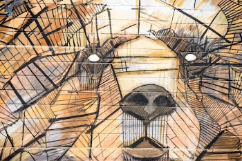 Textured street art of a bear's face