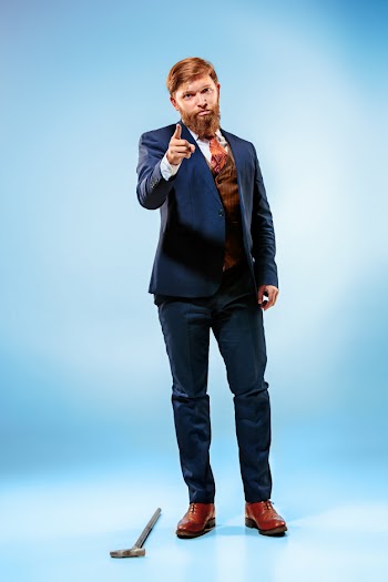 The barded man in a suit holding cane. Free Photo