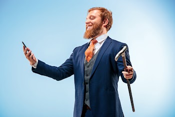 The barded man in a suit holding cane. Free Photo