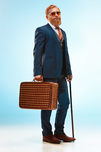 The barded man in a suit holding cane. Free Photo