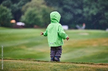 The boy walks the golf course