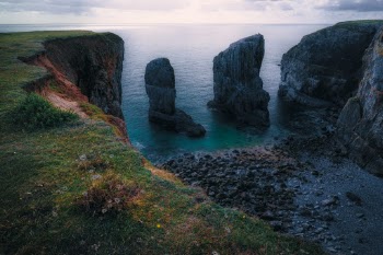 The Elegug stacks, separated from the land, standing as two massive pillars that have watched a thousand sunsets.