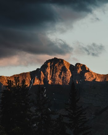 The evening sun showers the grey glaciers of Banff with gold