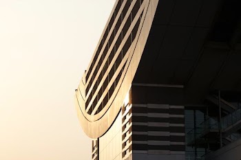 The facade and roof of a modern building in bright sunlight