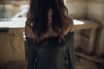 The girl bowed head and dropped her hair