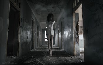 The girl floating in the dark hallway