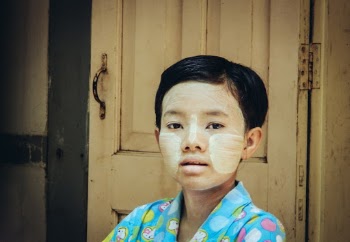 The girl in monastery // Young girl in Buddhist monastery helping to prepare table with food for monks.