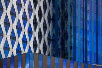 The glass towers of Manchester with interesting geometrical structures and shadow-light rhythm.